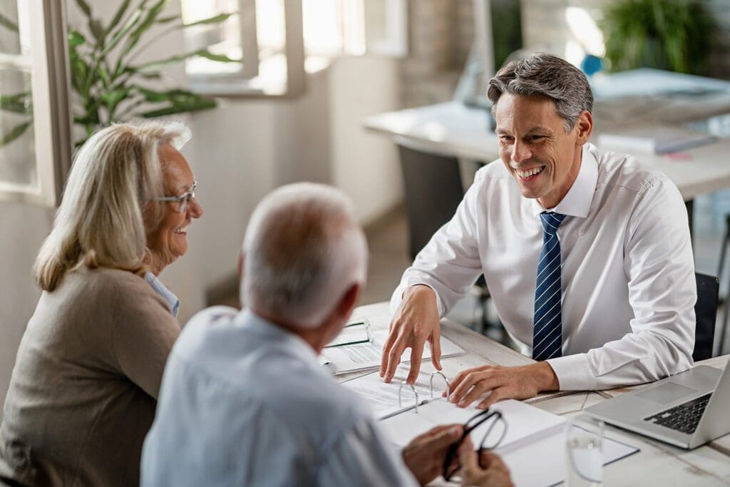 Insurance-Agent-showing-homeowners-the-benefits-of-getting-title-insurance-before-they-sell